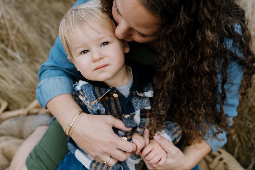 Mom snuggles her little son
