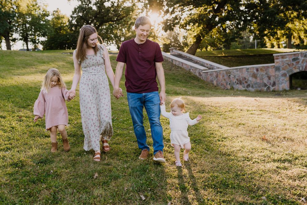 Family walks happily together during fall family photos