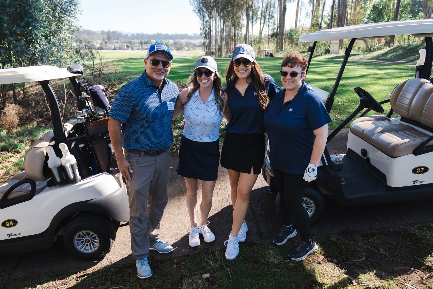 A group of golfers pose for a picture in front of their carts at a course in Nipomo.