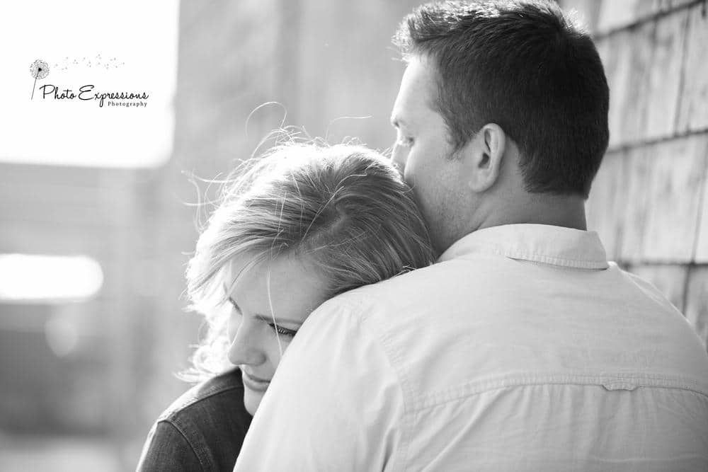 Black and white portrait of couple sharing intimate moment.
