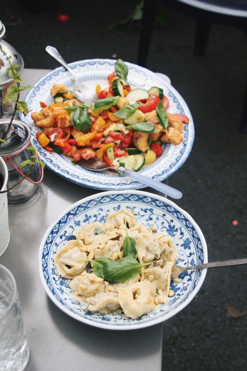 Chinese dishes served on traditional blue and white patterned plates including dumplings and stir-fry.