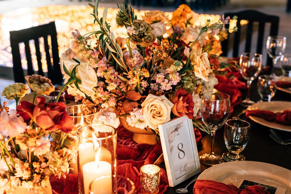 Romantic wedding reception table setting with candlelight and lush floral arrangements, Blue Venado, Mango Weddings.