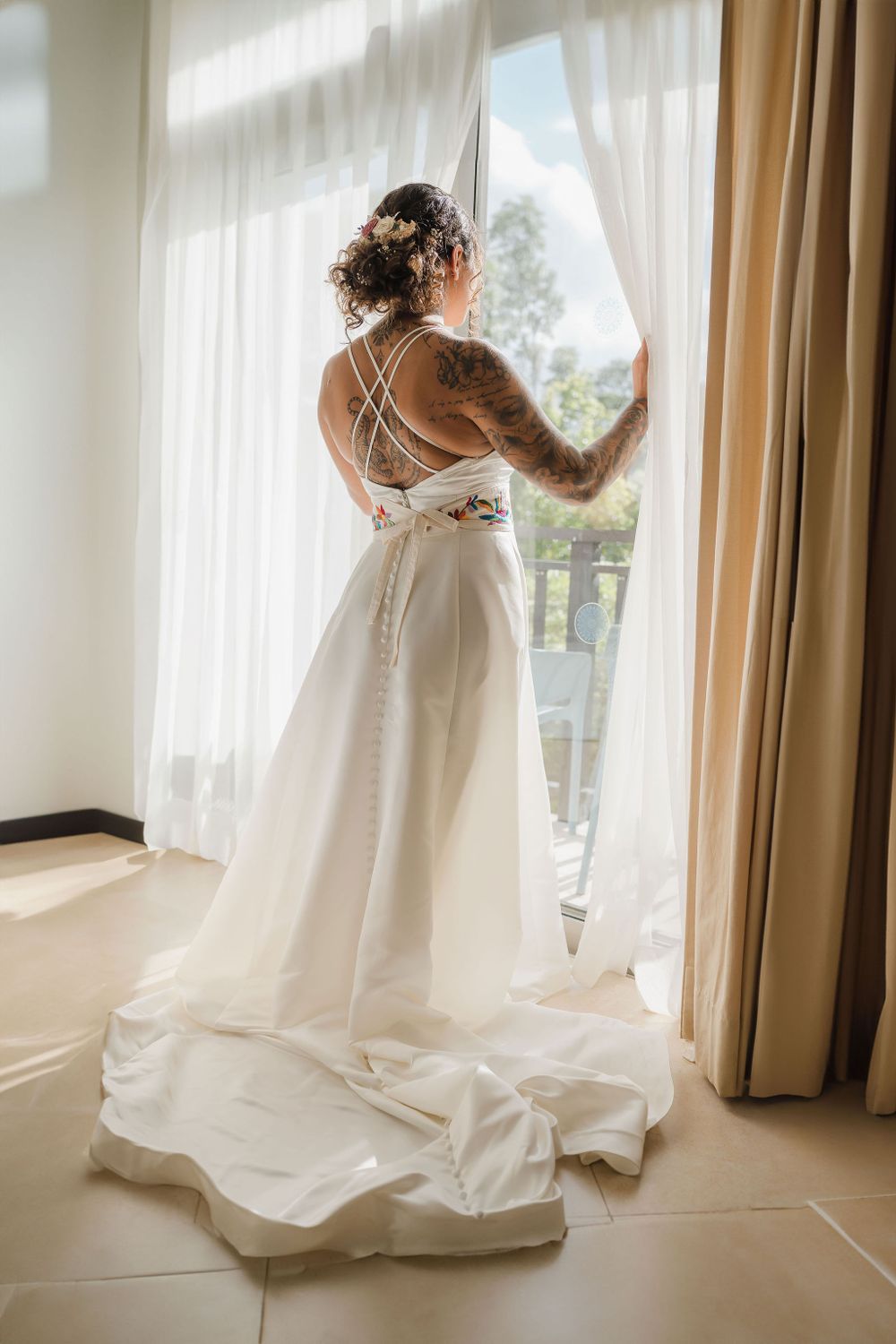 White wedding dress flowing elegantly against natural window light in a bedroom setting, Sandos Caracol Wedding.