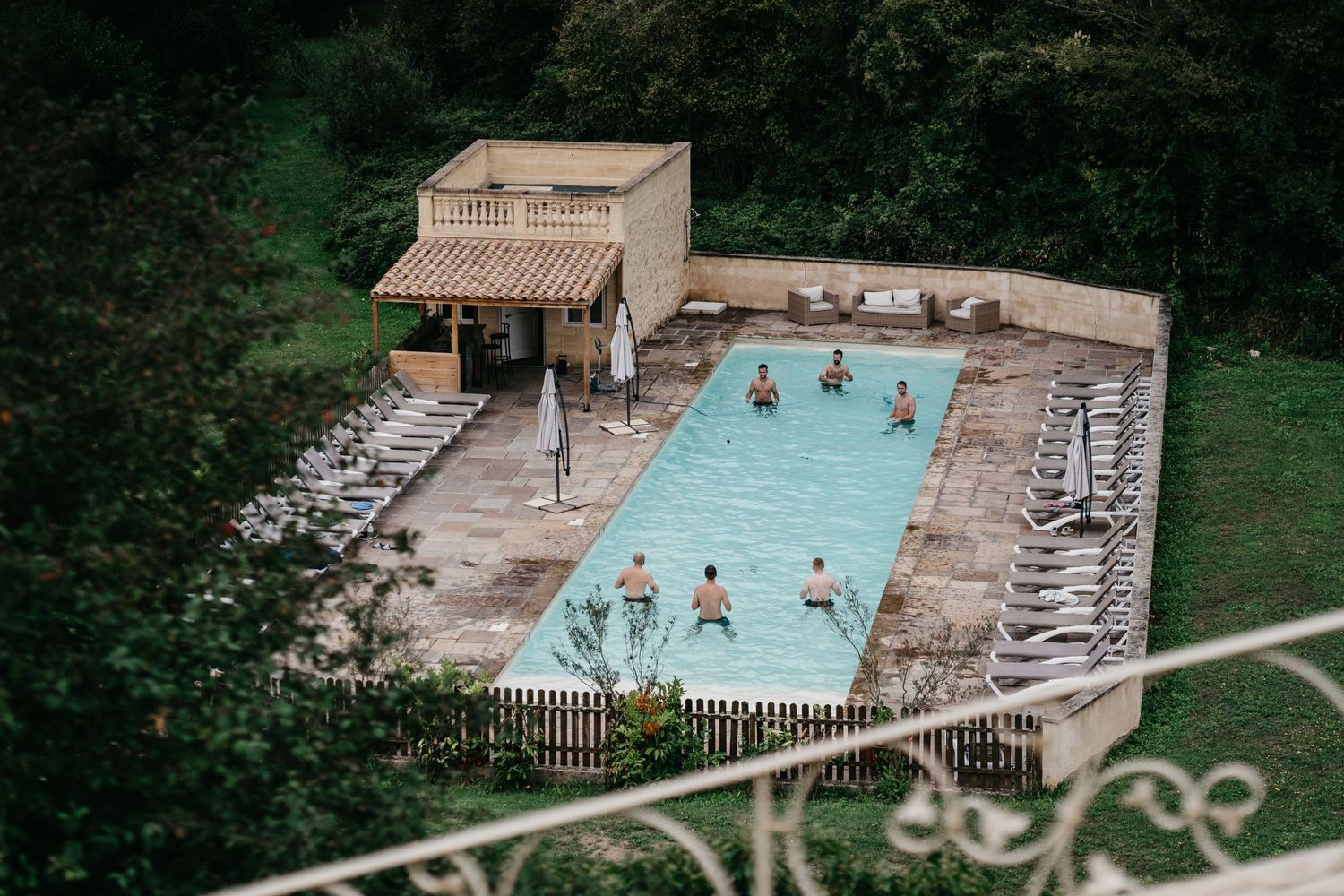 groomsmen in the swimming pool at Chateau Lagorce