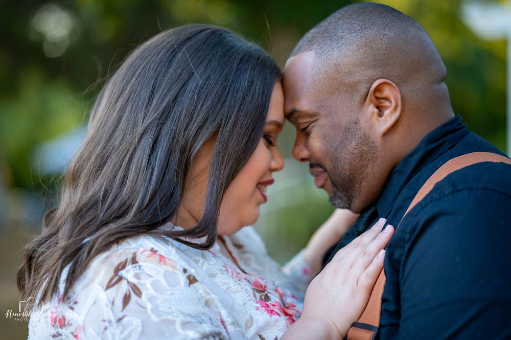 Romantic engagement photos captured in outdoor natural setting.