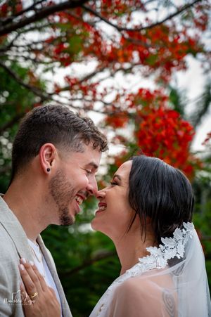 A romantic wedding photo series under vibrant red autumn leaves.