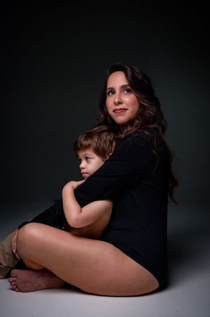 Intimate studio portraits captured against a dark background.