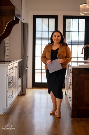 Professional photoshoot in modern kitchen with hardwood floors.