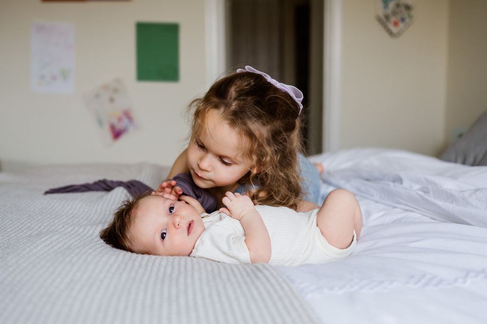 new-big-sister-admiring-baby-brother