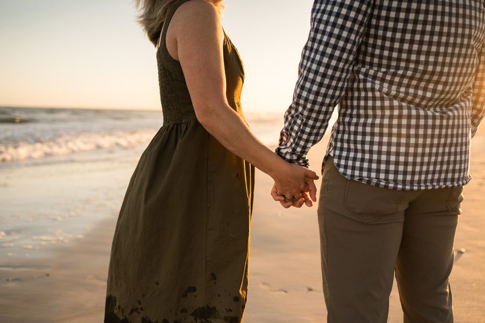 couple-holding-hands-at-sunset