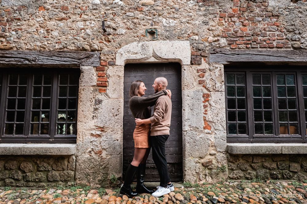 Rustic brick wall backdrop with vintage windows creates industrial atmosphere.