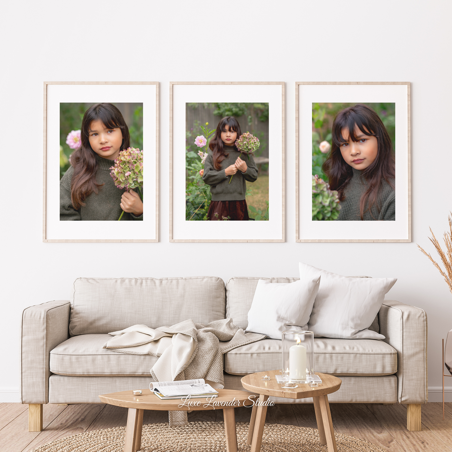Modern living room interior with three framed photos of motherhood above light gray sofa and wooden coffee table with decor. mom and baby.