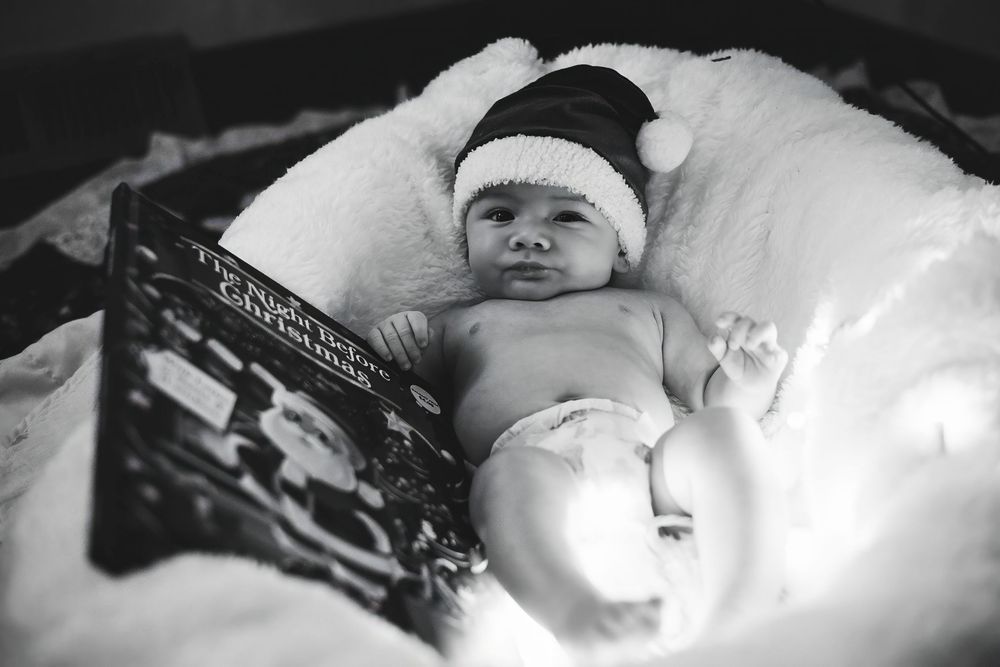 Black and white photo series of a sleeping infant in soft lighting.