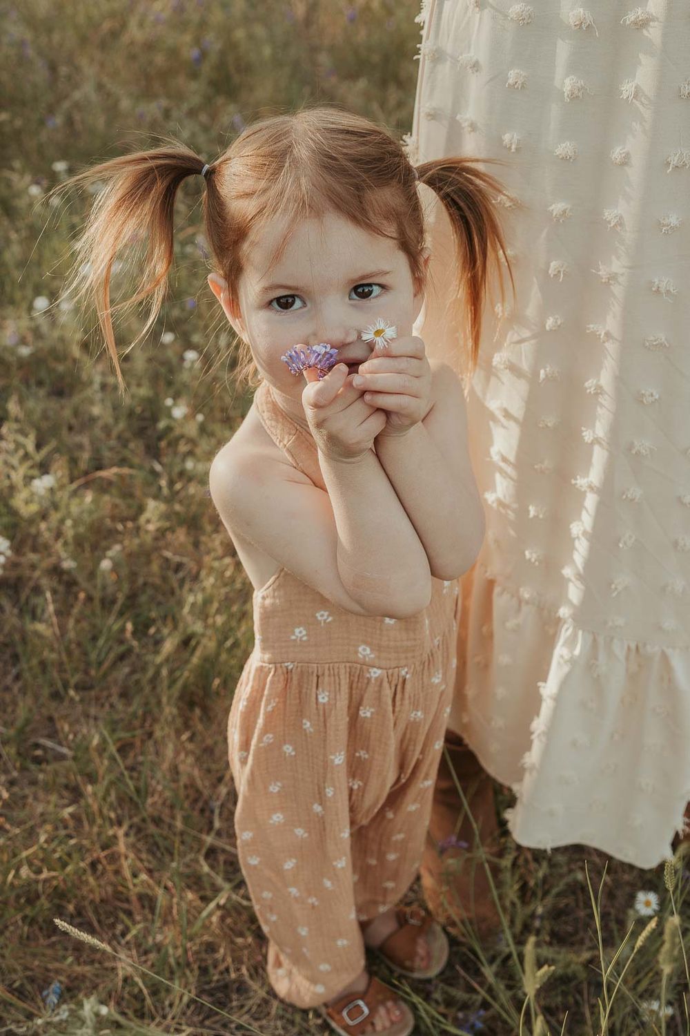 little girl in a flower field at golden hour with a spokane family photographer
