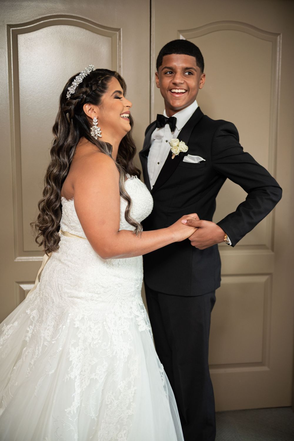 Joyful couple sharing a laugh during their wedding portrait session.