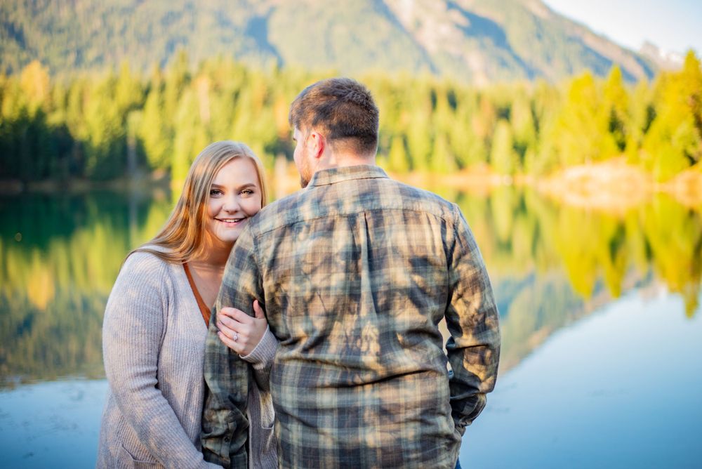 Man and woman pose for an engagement photography photoshoot at Gold Creek Ponds at Snoqualmie Pass, WA