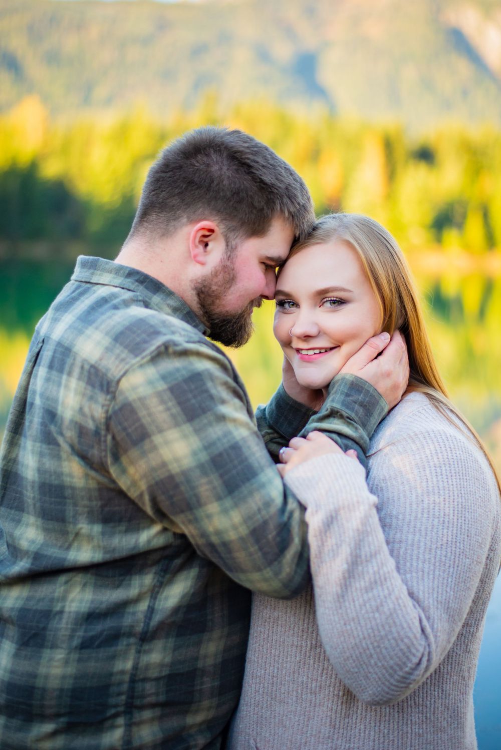 Man and woman pose for an engagement photography photoshoot at Gold Creek Ponds at Snoqualmie Pass, WA