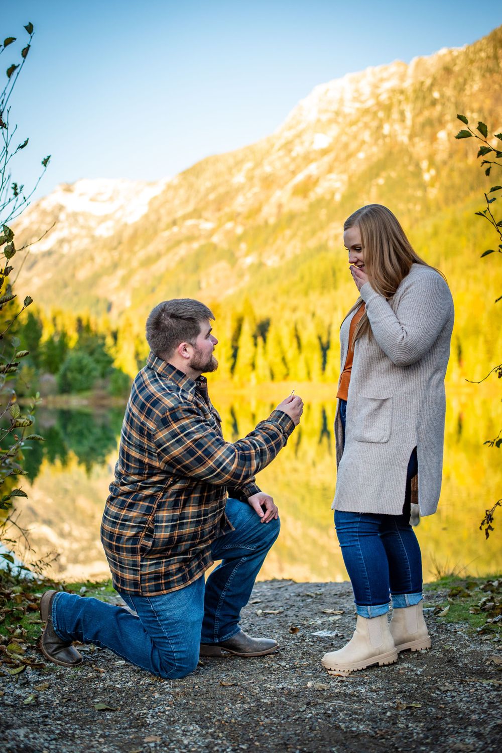 Man and woman pose for an engagement photography photoshoot at Gold Creek Ponds at Snoqualmie Pass, WA