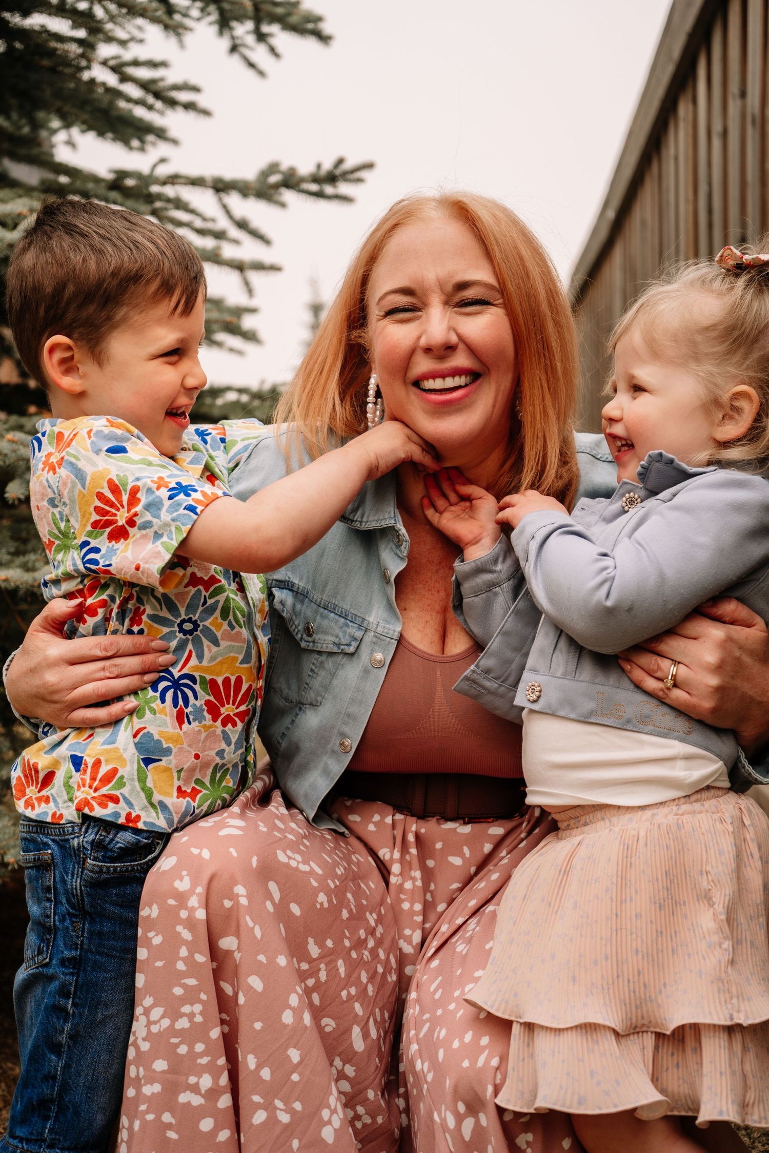 Candid family moments captured outdoors with playful interactions and floral spring outfits.