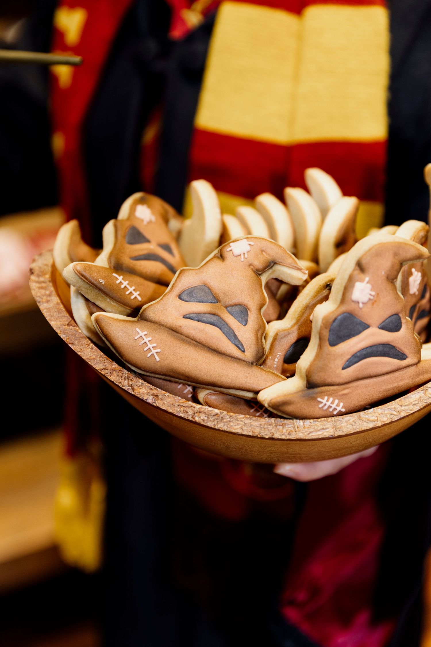 A series of brown leather football-shaped decorative bowls with white stitching details arranged in a row.