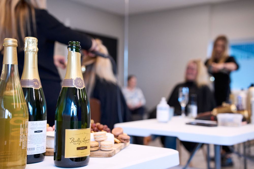 Champagne bottles and refreshments set up on a table at a celebration event.