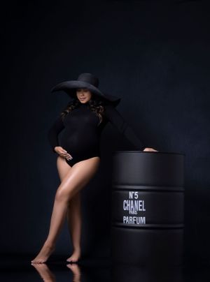 Fashion photos with Chanel props featuring model in black outfit and hat.