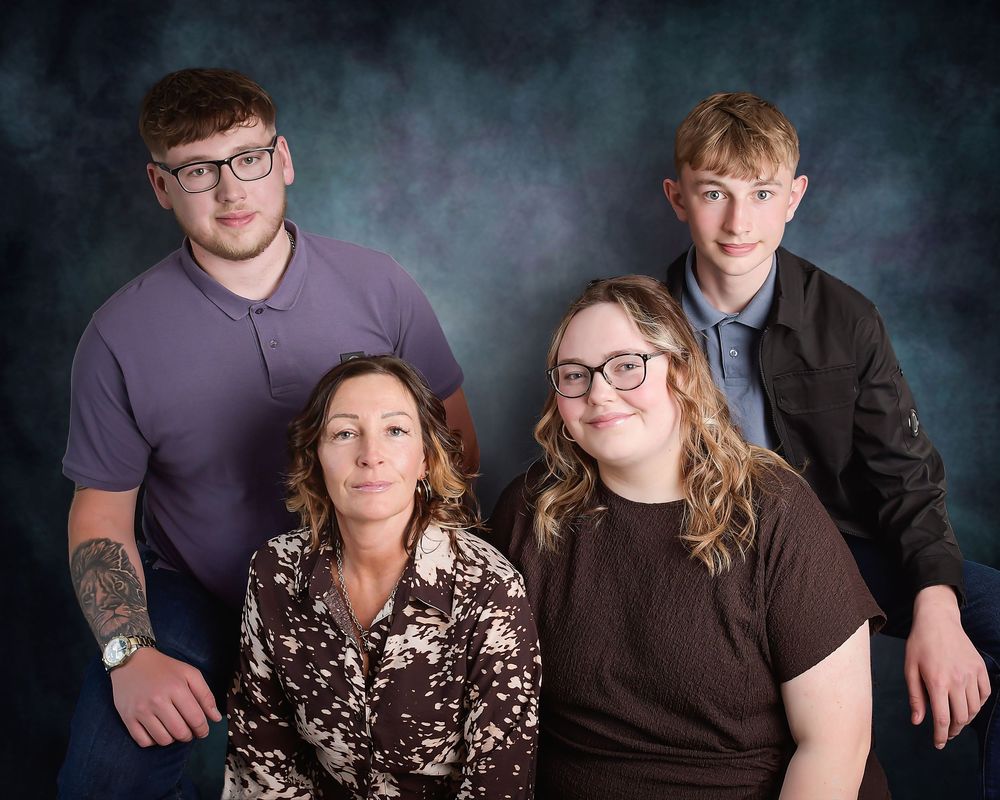 Family photography by Nicola in Woodside, capturing mother with children in a studio portrait full of love and timeless connection.