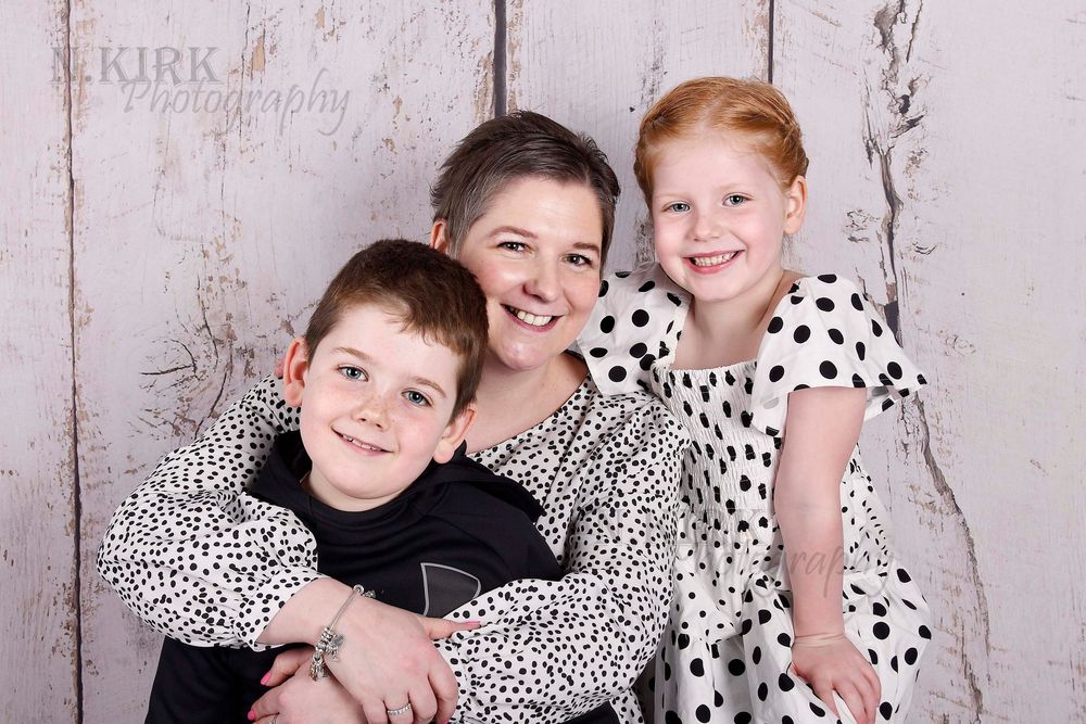 Mother’s Day family photography by Nicola in Woodside, capturing mother with daughter and son in a warm studio portrait of love, connection
