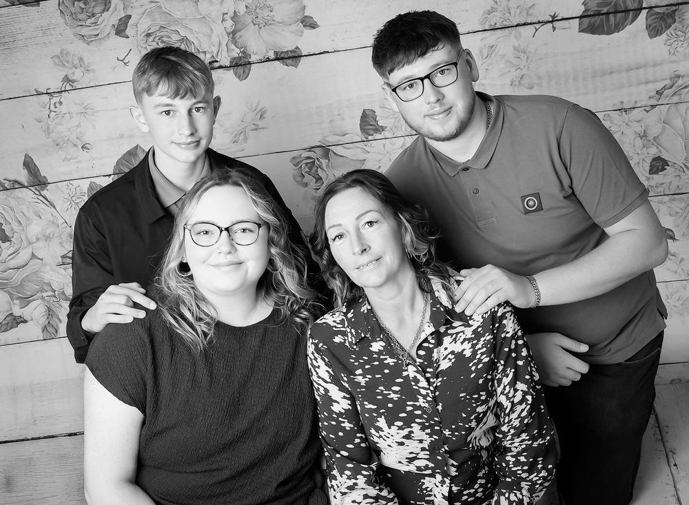 Black and white family photography by Nicola in Woodside, capturing mother and children in a timeless, emotional studio portrait full of lov