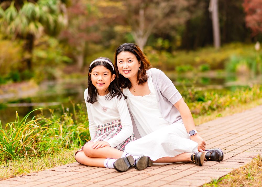 A series of outdoor photos showing people sitting and interacting in a garden setting with cypress trees.
