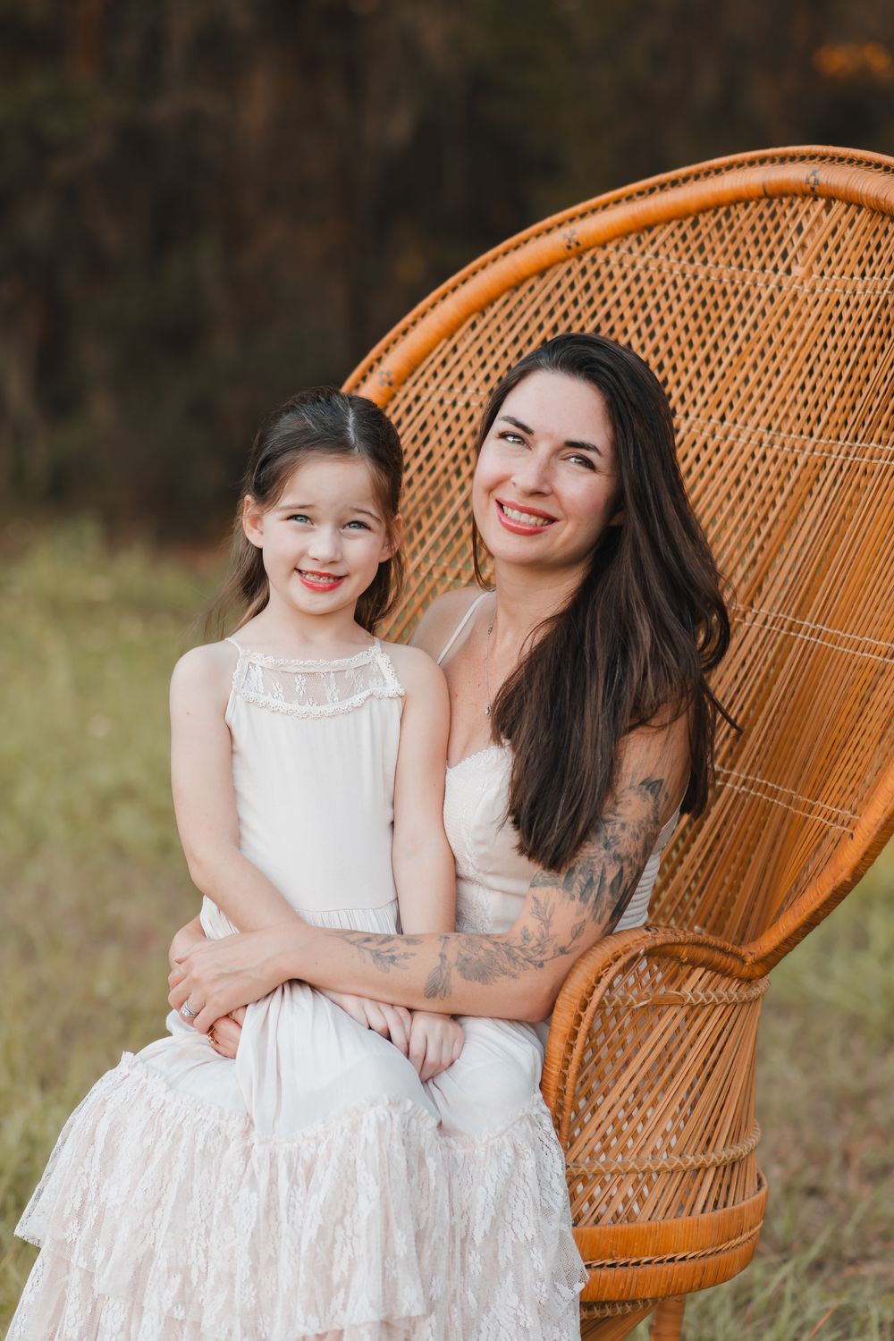A series of photos showing a mother and daughter in white dresses sitting together on a wicker peacock chair outdoors.