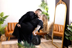 Sweet dancing moment captured in a studio setting with vintage decor and plants.