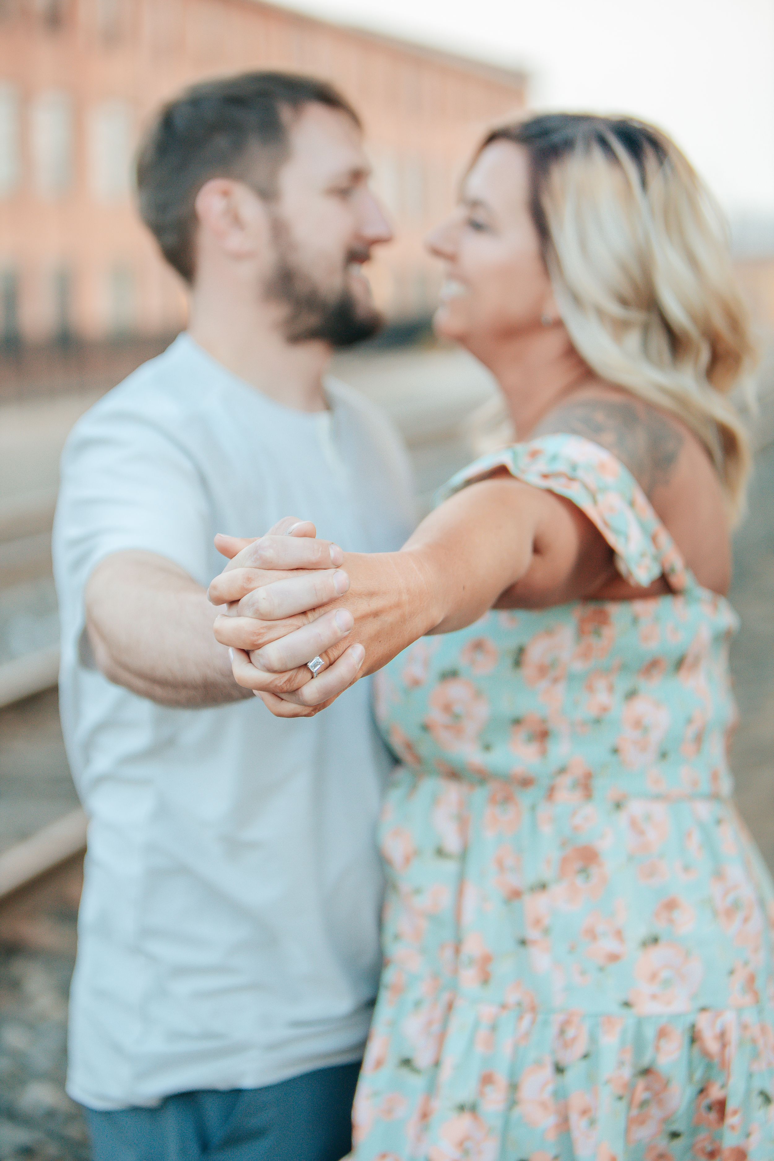 Romantic couple dancing and smiling together in a tender moment.