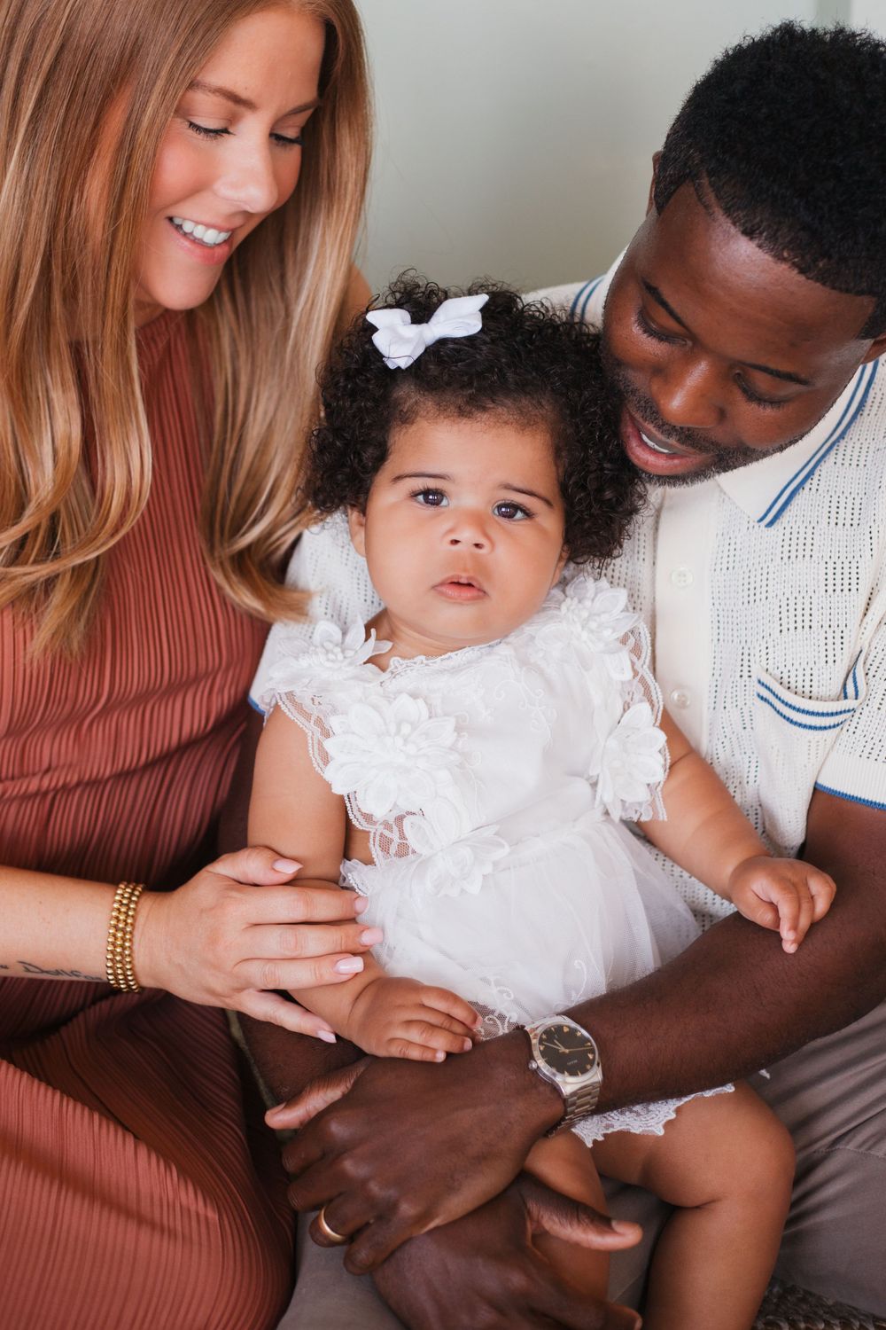An intimate family portrait showing three people sharing a loving moment together.