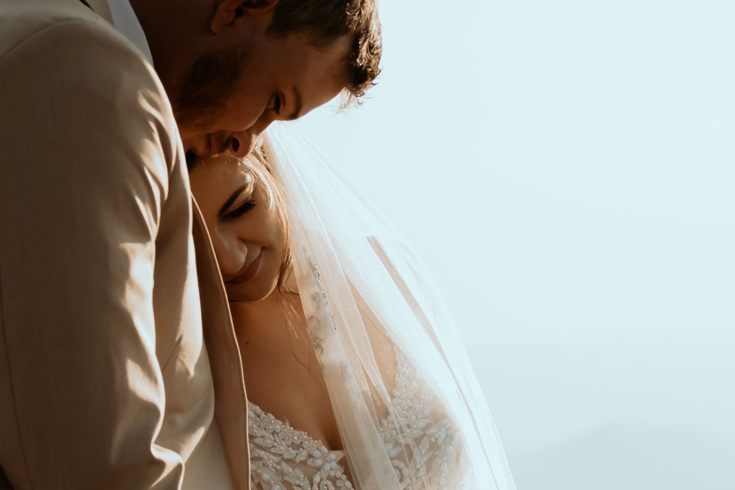 Bride with her head on the groom, both smiling during their elopement wedding at Intiem Wedding Venue Pretoria