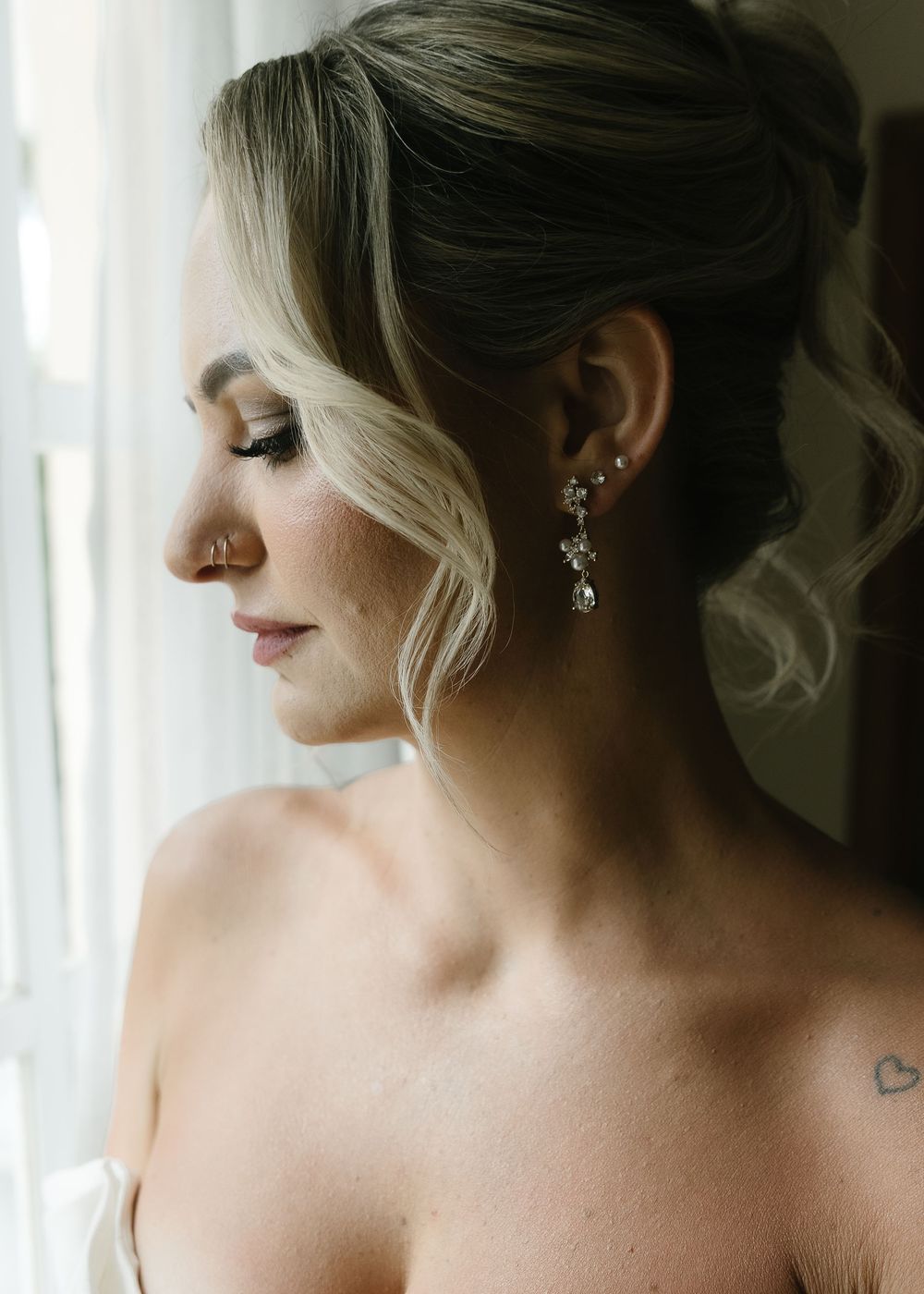 A series of artistic profile shots showcasing an elegant updo hairstyle with blonde highlights and delicate earrings.