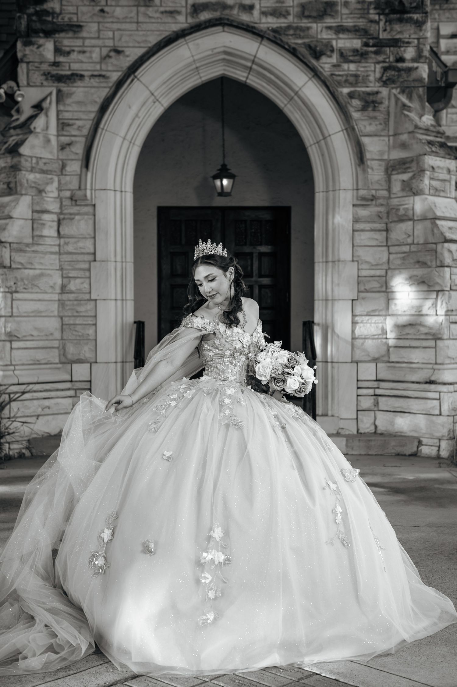 A elegant portrait in a sparkly gold gown surrounded by white roses and pampas grass.