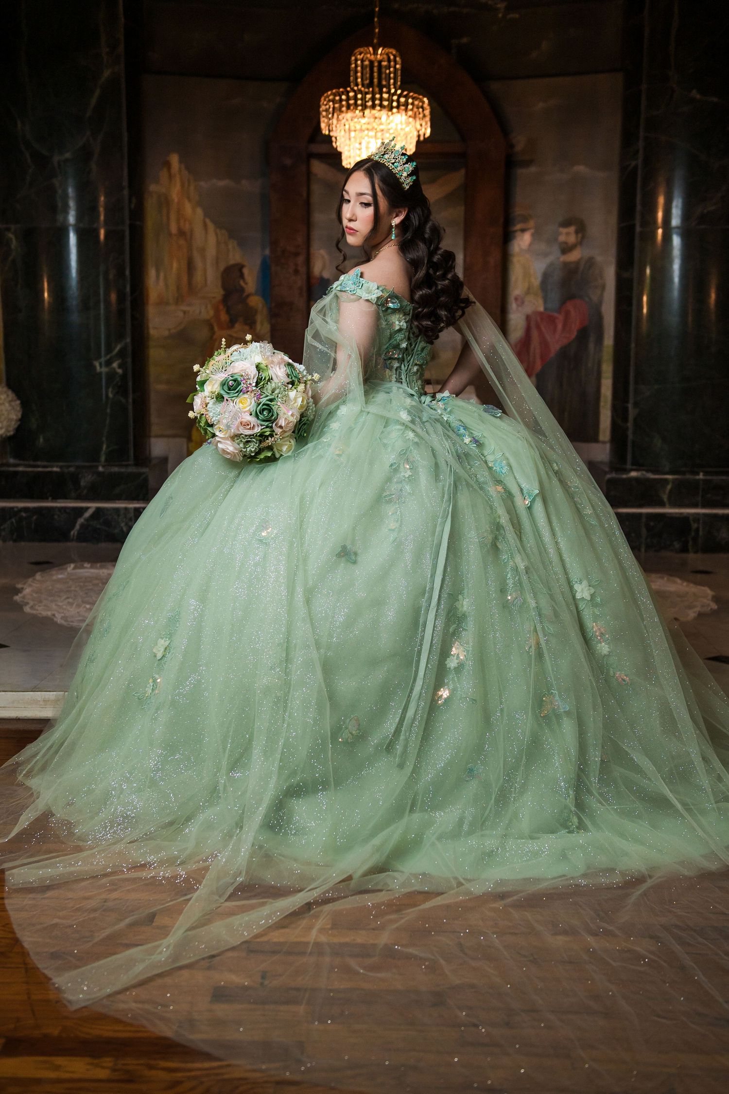 A elegant portrait in a sparkly gold gown surrounded by white roses and pampas grass.