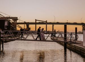 Silhouetted couple on dock during sunset wedding photo session.