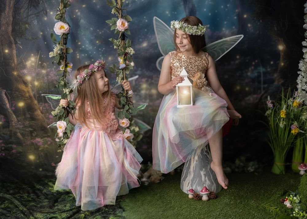 Magical fairy tale scene in enchanted forest with glowing lights and flowing pink dress against dark backdrop.