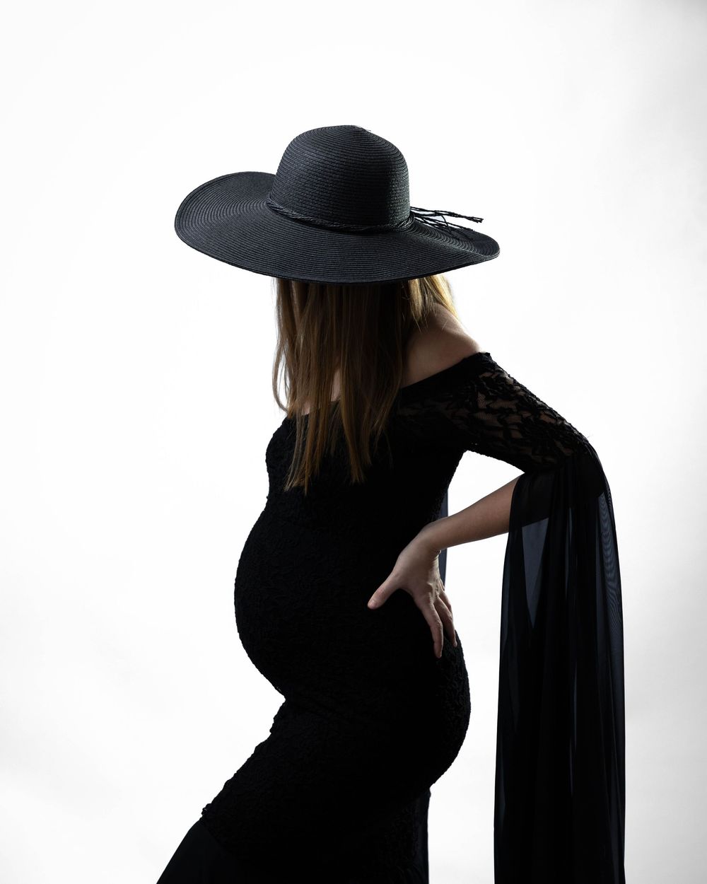 Artistic black and white silhouette series showing a figure in a wide-brimmed hat against a white background.