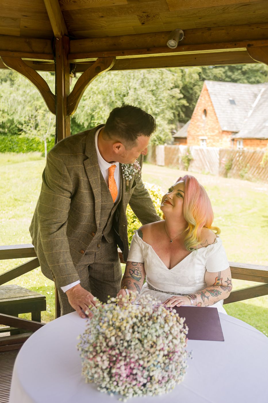 A romantic wedding photoshoot sequence outdoors under a wooden gazebo with a delicate baby's breath bouquet.