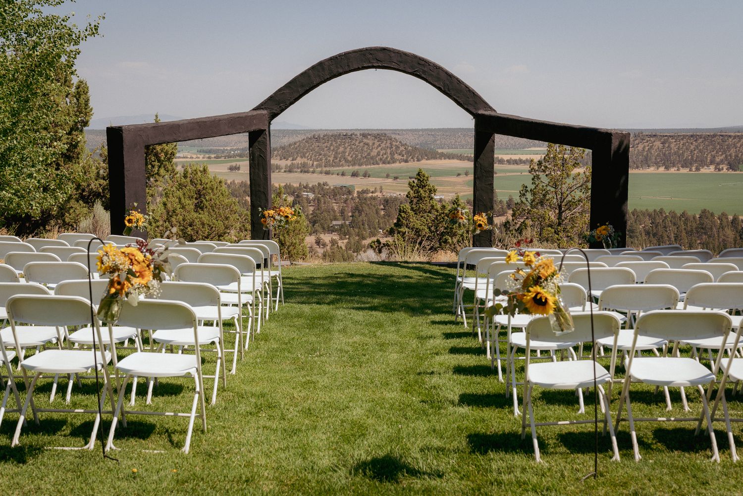 Ceremony site with mountain views and fall florals, PNW outdoor wedding.