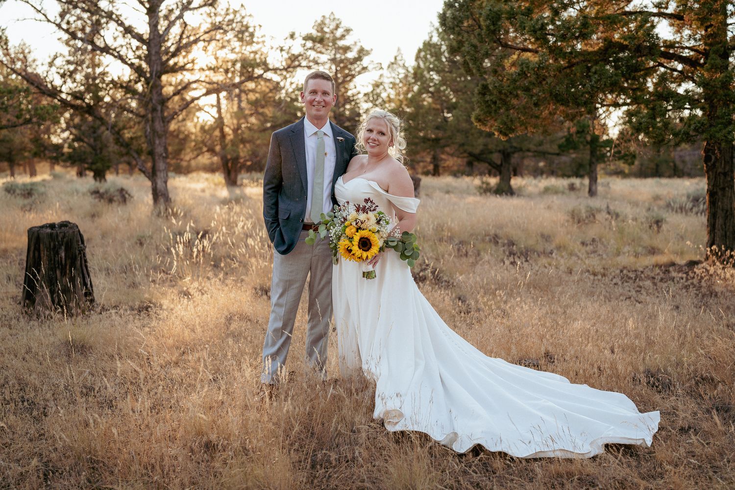 Bride with sunflower bouquet in Central Oregon meadow.