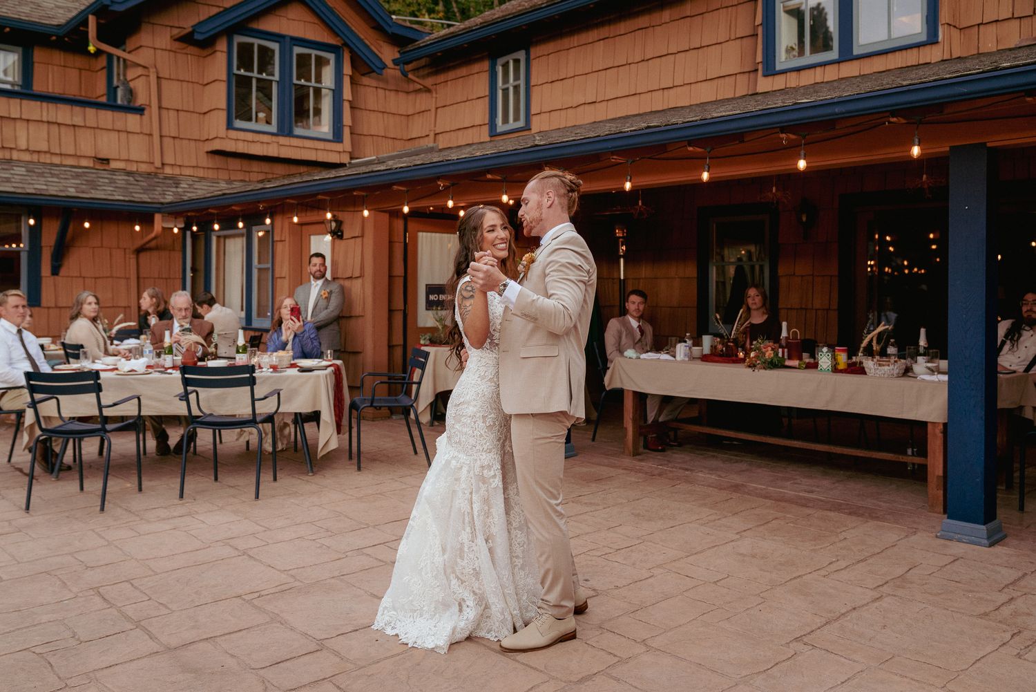 Bride and groom share first dance at a small, private wedding in a cozy cabin surrounded by Oregon woods. Intimate forest celebration.
