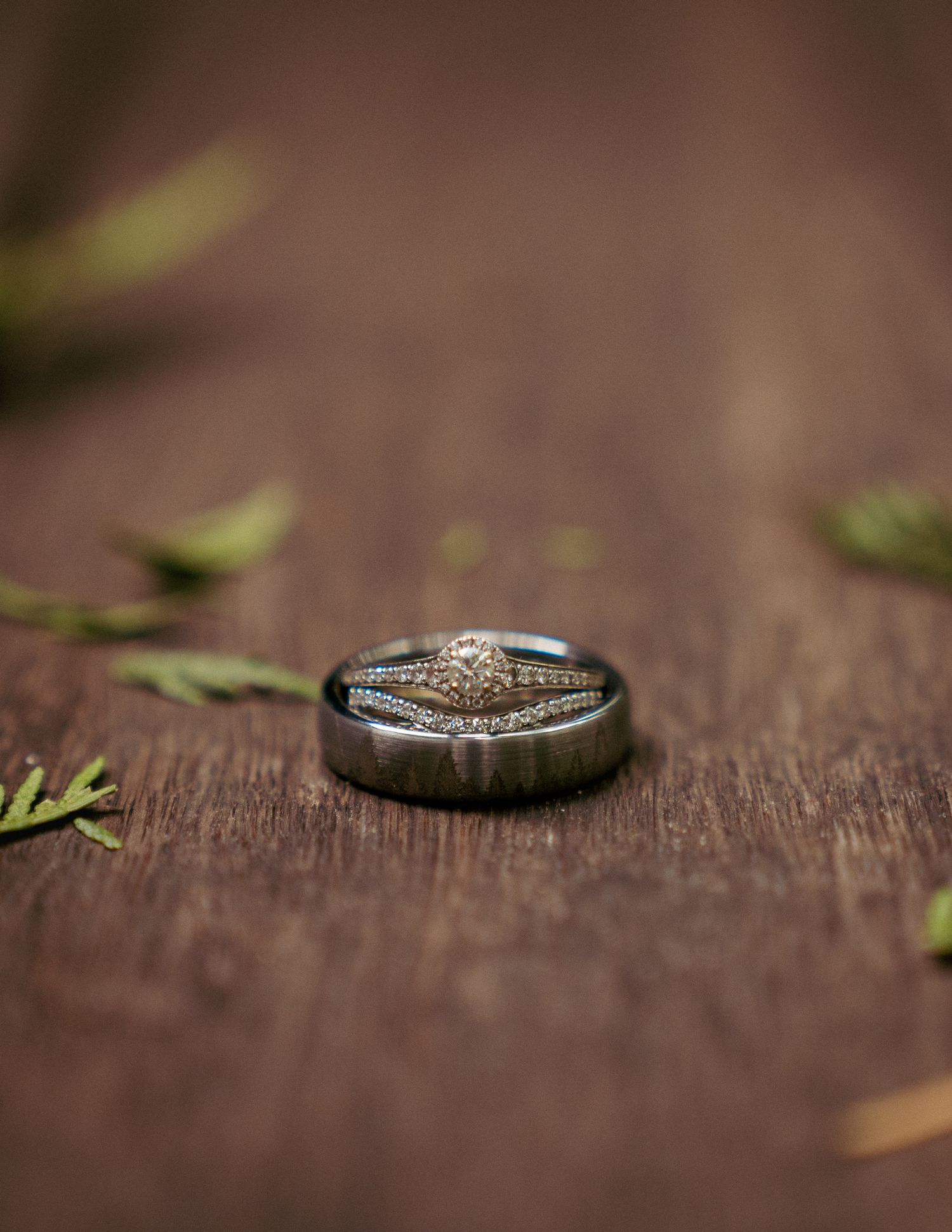 Close-up of dark wood ring with leaf accent, rustic wedding detail.