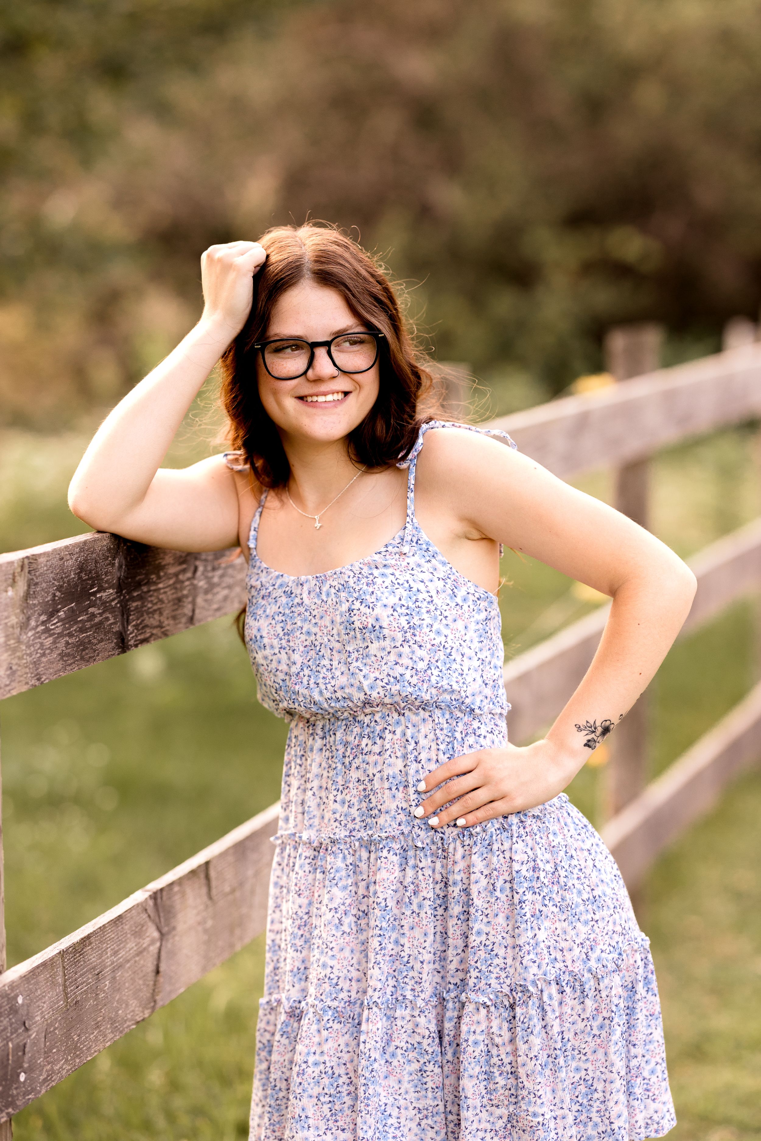A blue floral sundress is showcased in a series of casual outdoor poses.