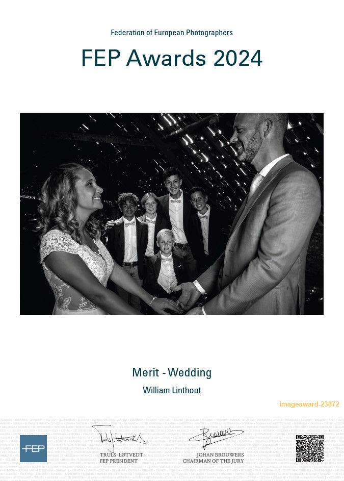 A black and white wedding ceremony photo showing a couple exchanging vows under twinkling lights.