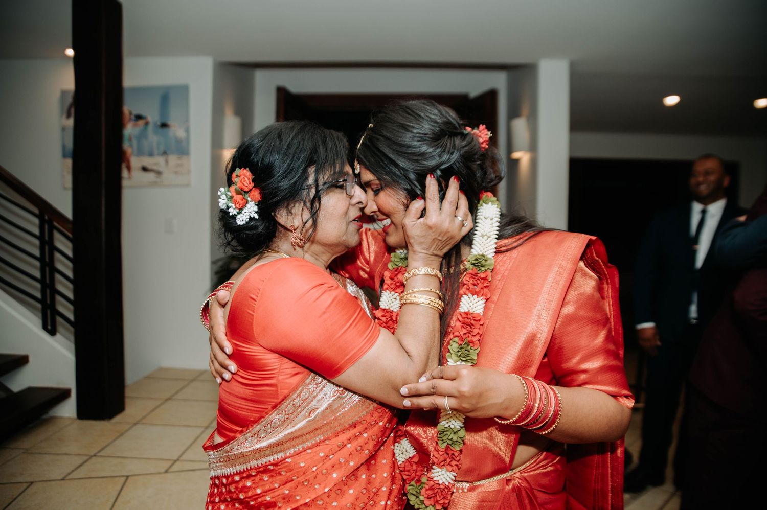 Two people share an intimate moment during wedding festivities.