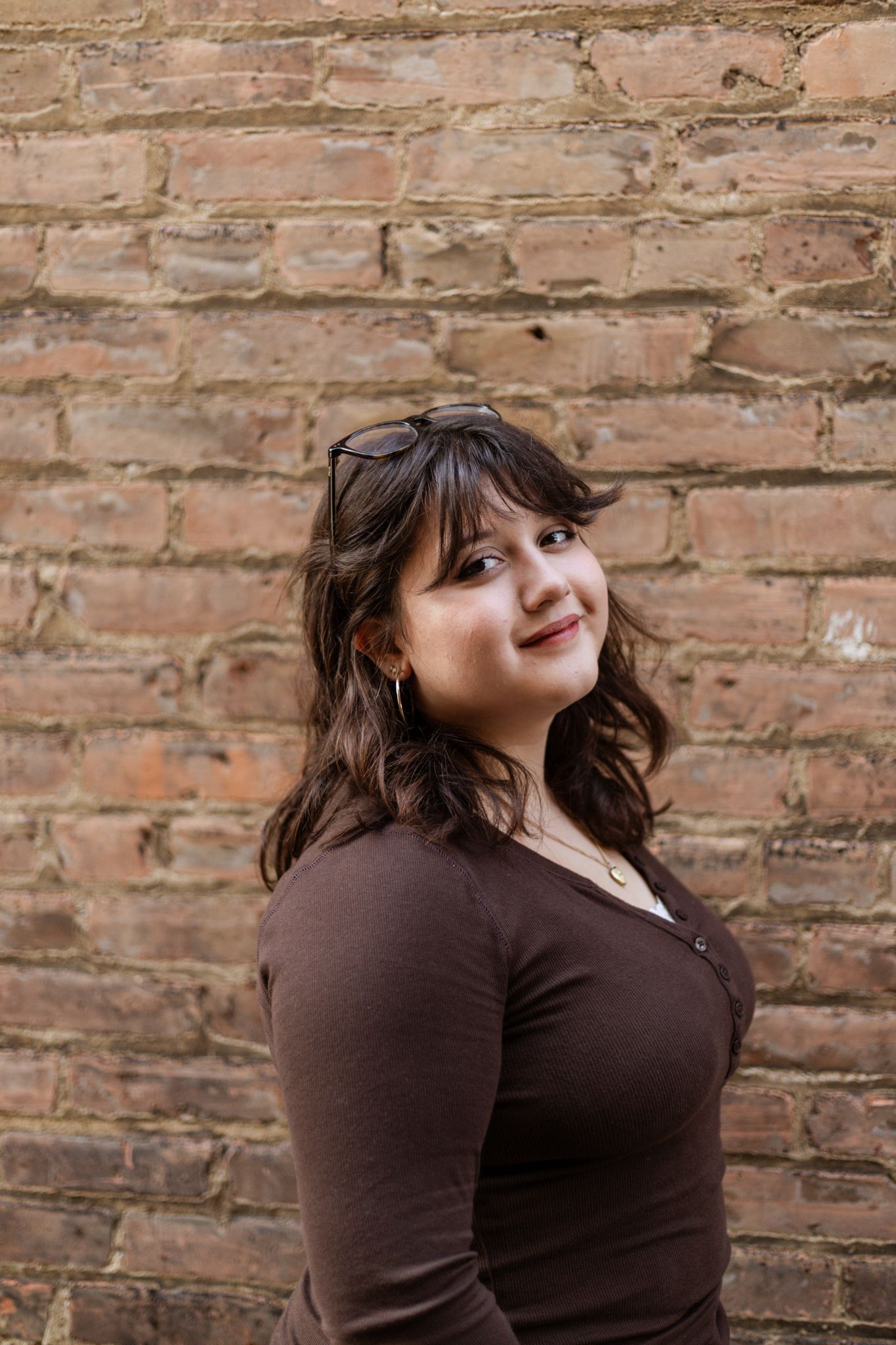 A brown brick wall background with warm lighting creating an artistic ambiance.